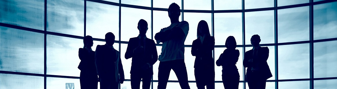 Confident business leaders in front of a window