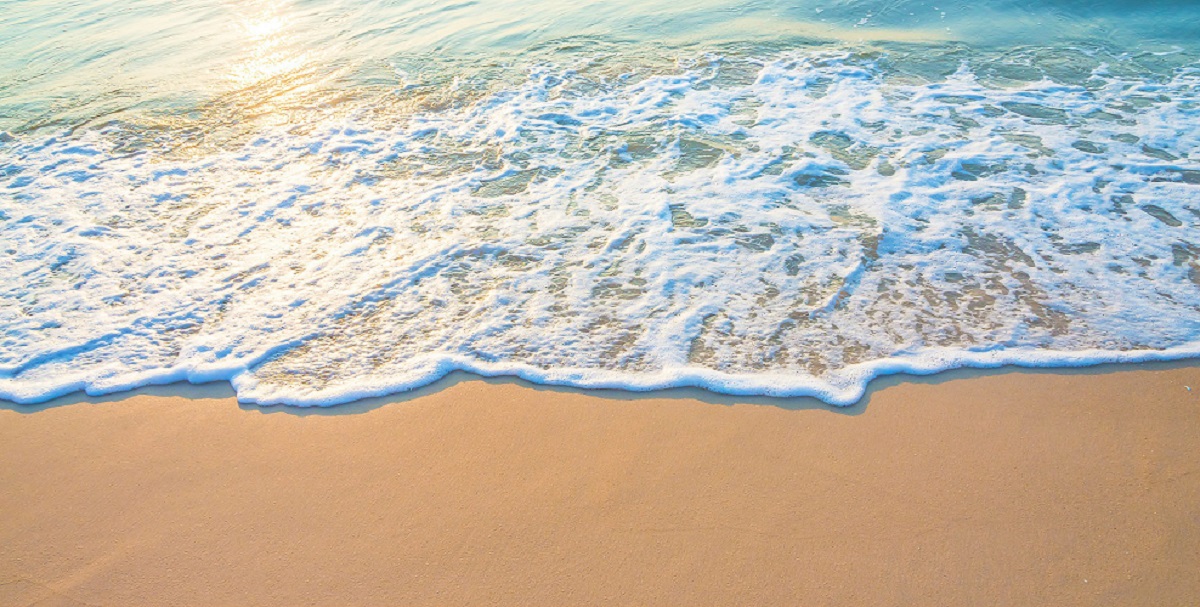 A colour photograph of the ocean on the beach